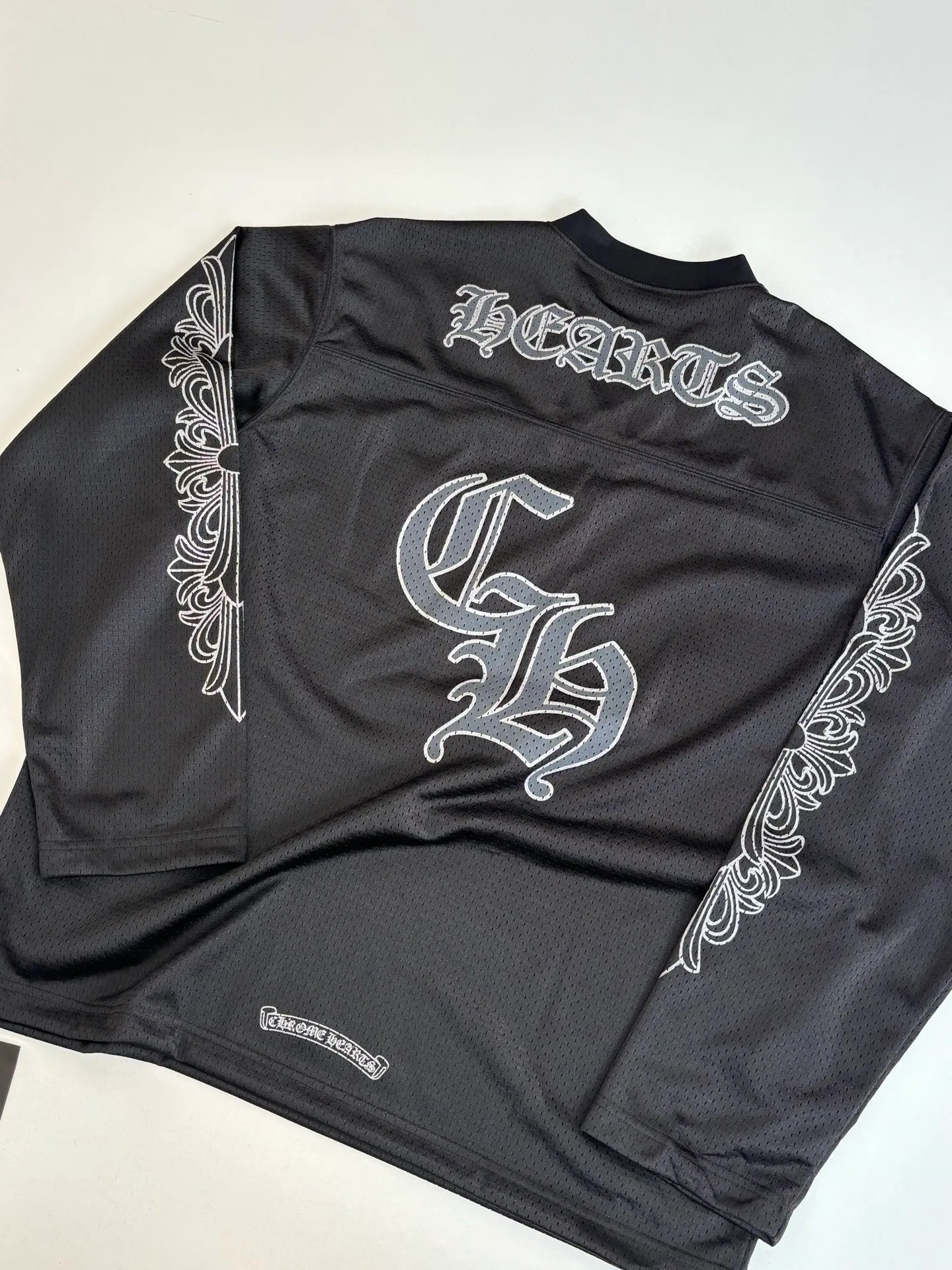 P340 Chrome Heart*/Chrome Heart Sanskrit mesh ice hockey suit long sleeves. The original version was purchased for 15,989 and developed. The fabric is made of custom weaving and dyeing technology. It is made of selected black mesh fabric, showing a unique sports style. The fabric has been specially treated to provide excellent breathability and comfort while maintaining a crisp and structured look. The double-layer design structure enhances the overall texture and makes the wearing experience more three-dimensional and full. The brand's iconic patterns are printed in many places, and high-precision printing technology is used to ensure that the patterns are clear and sharp. The silver printing has a glitter effect, showing charming luster changes under different lights. All printings undergo strict color difference control to ensure accurate color reproduction. The silver-plated pattern design on the sleeve arms is particularly eye-catching, showing the brand's consistent dark luxury style. In terms of details, the latest custom-woven labels are used, and the workmanship is exquisite. The overall shape is designed for both men and women, with both fashion and practicality. This T-shirt perfectly combines sports elements with high fashion craftsmanship, making it the brand's iconic street style item.  Size：S/M/L